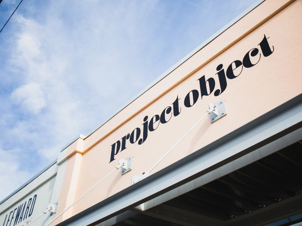 The project object wordmark on the peach storefront above the entrance.